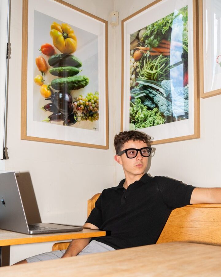 At a desk with a laptop, wearing Relay glasses.